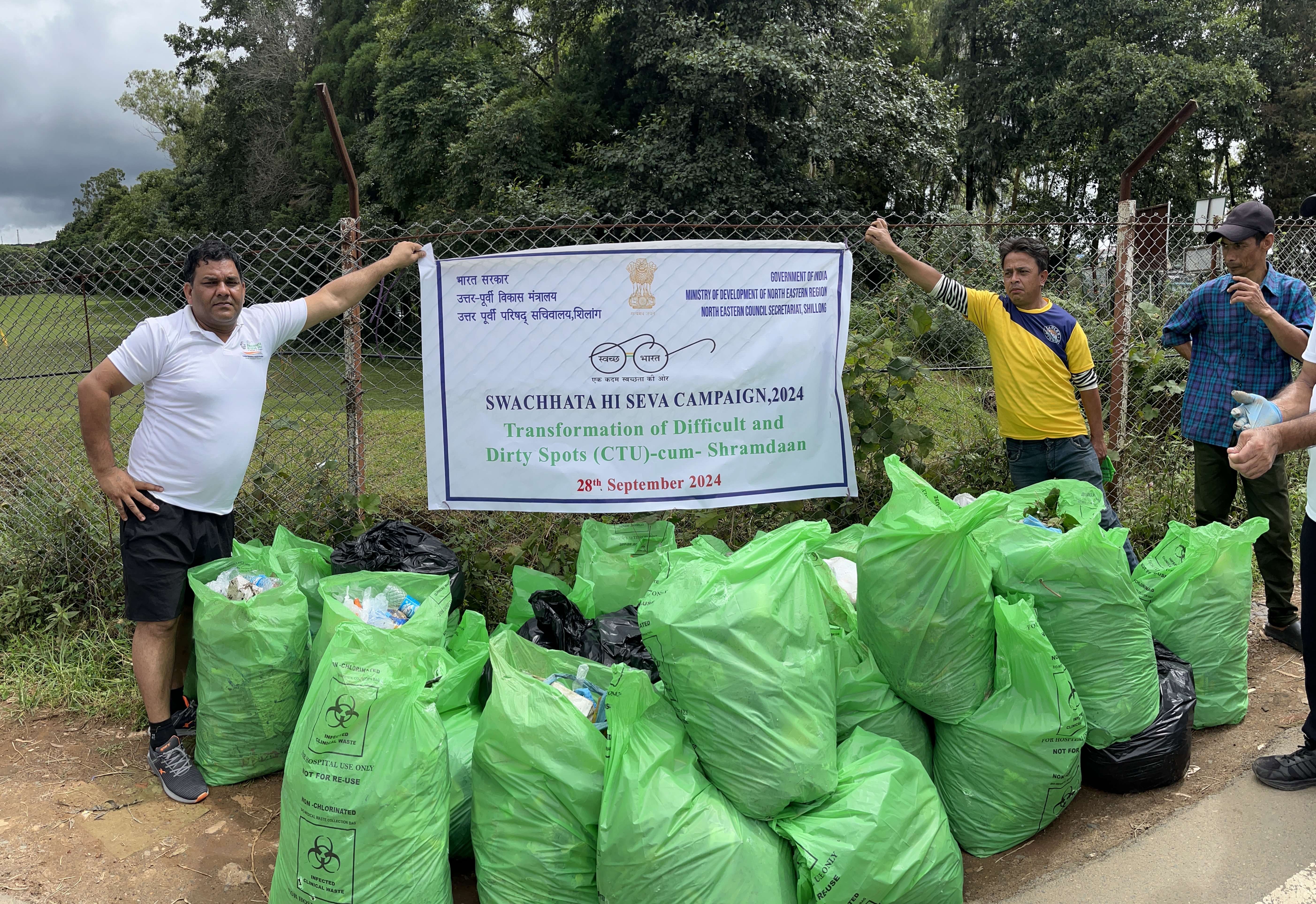 NEC officials with bags of trash collected during the Transf