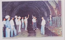 Officials inspect an under construction tunnel