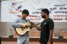 NEC employee participating in the Hindi music competition or